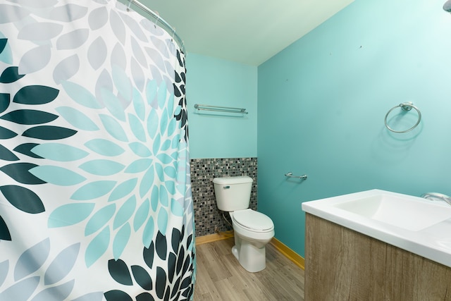 full bathroom with vanity, wood-type flooring, shower / tub combo, and toilet