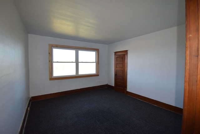 empty room with dark colored carpet