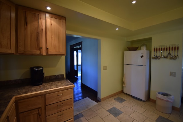 kitchen with white fridge and light wood-type flooring