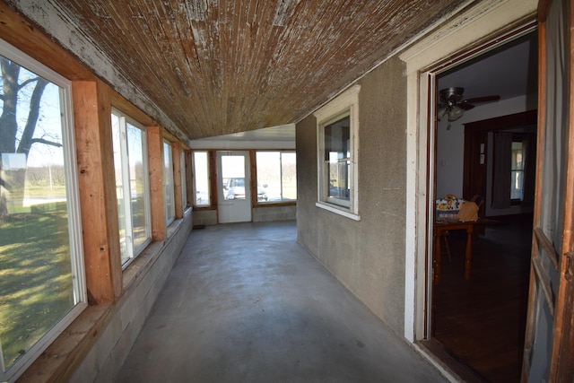 unfurnished sunroom featuring ceiling fan and lofted ceiling