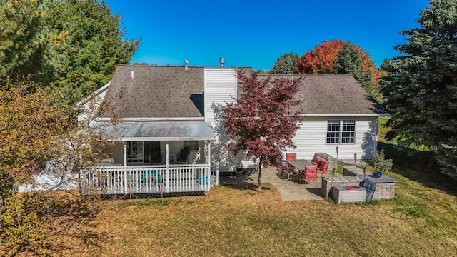 rear view of house with a yard, a patio, and a wooden deck