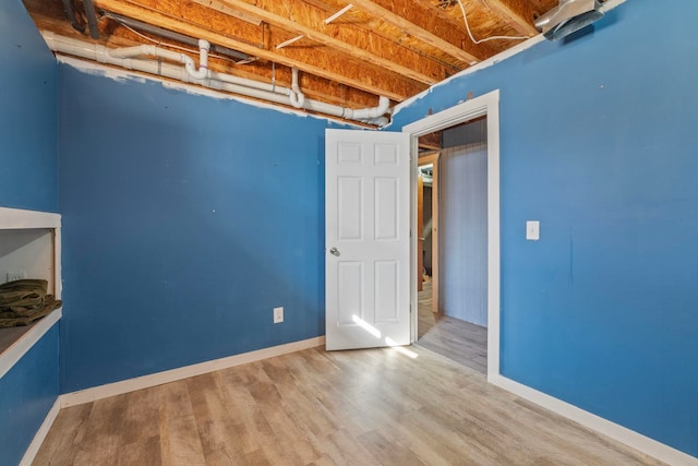 basement featuring wood-type flooring