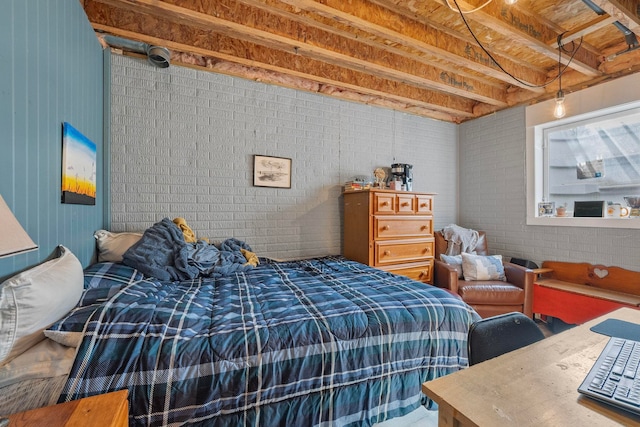 bedroom featuring brick wall