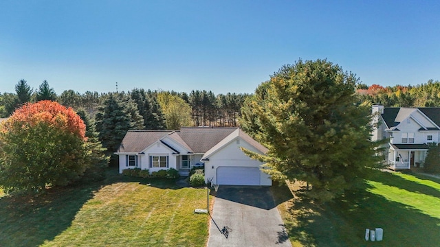 view of front of house featuring a front lawn and a garage