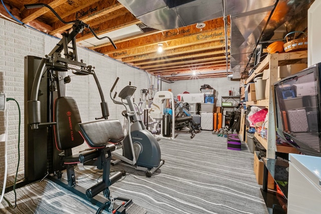 exercise room with brick wall