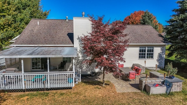 rear view of house with a lawn, a patio area, and a wooden deck