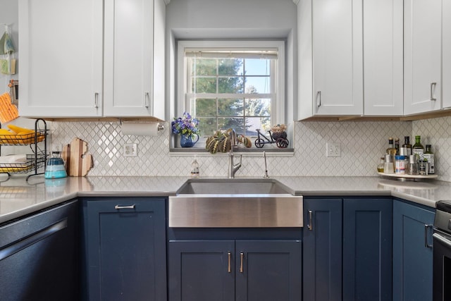 kitchen with white cabinets, dishwasher, blue cabinets, and sink