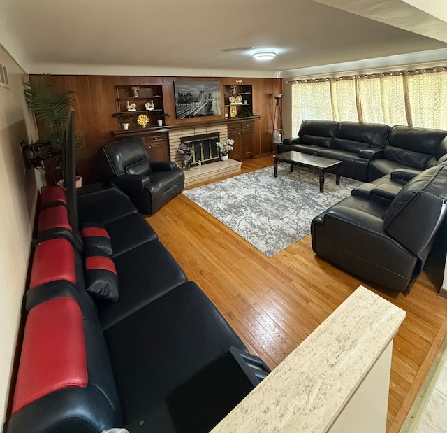 living room with wood-type flooring and a fireplace