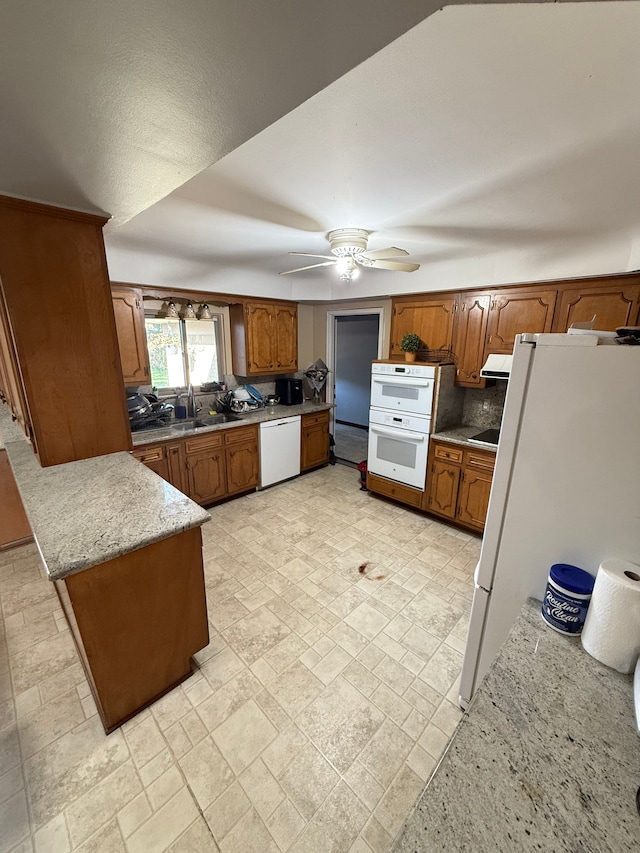 kitchen featuring ceiling fan, white appliances, sink, and tasteful backsplash