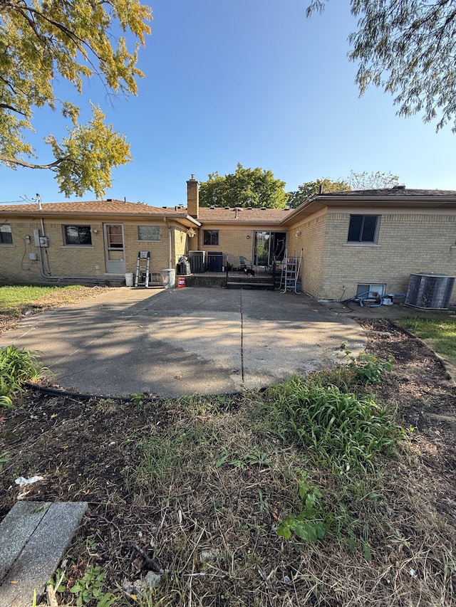 back of property with a patio area and central AC unit