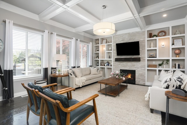 living room featuring coffered ceiling, built in shelves, wood-type flooring, beam ceiling, and a fireplace