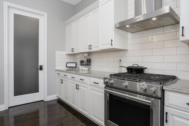 kitchen with backsplash, dark wood-type flooring, wall chimney range hood, high end stainless steel range, and white cabinetry