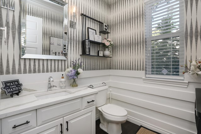 bathroom featuring vanity and toilet