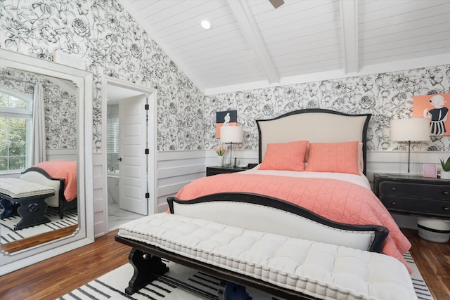 bedroom featuring ensuite bathroom, dark wood-type flooring, and vaulted ceiling