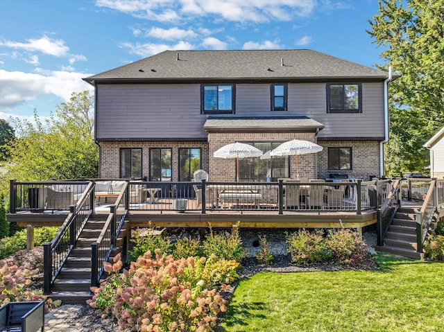 back of property with a lawn and a deck