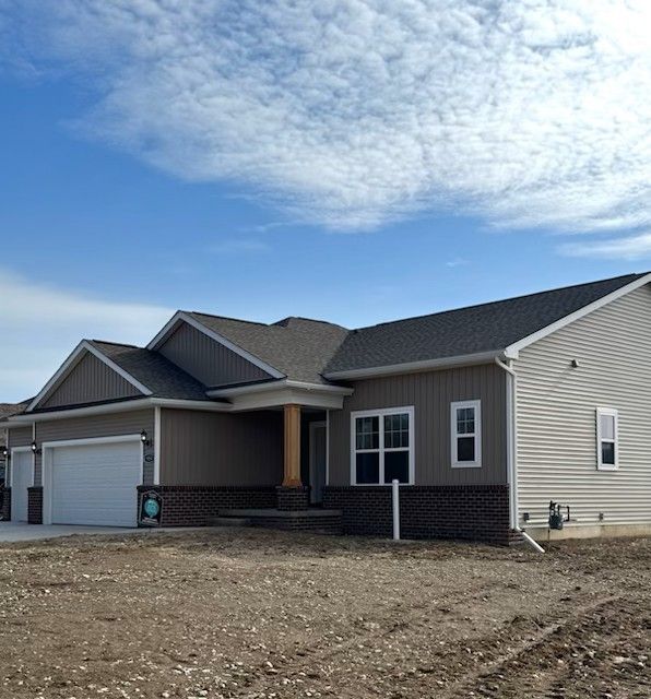 view of front facade featuring a garage and brick siding