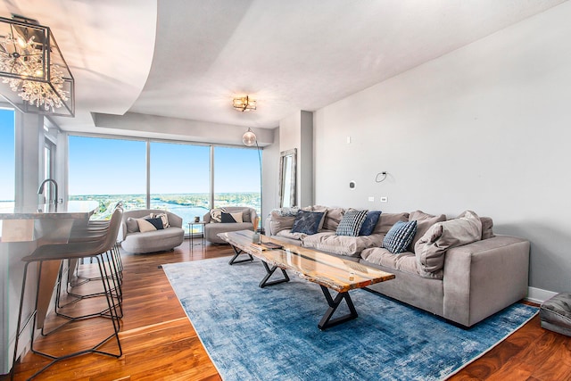 living room with hardwood / wood-style floors and a chandelier