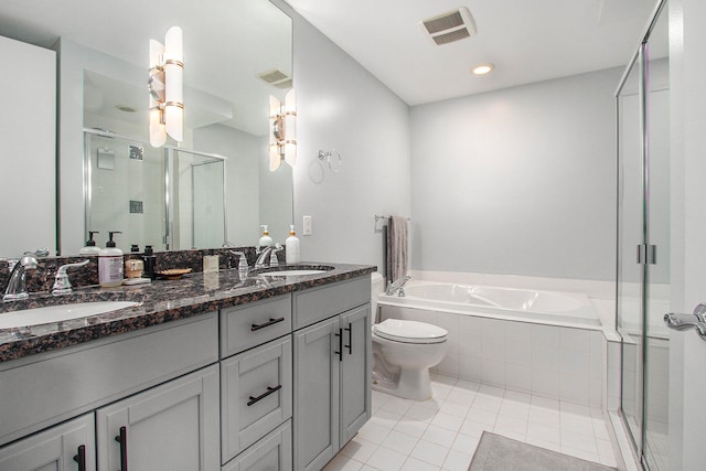 full bathroom with tile patterned floors, vanity, shower with separate bathtub, and toilet