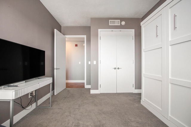 unfurnished bedroom featuring light carpet