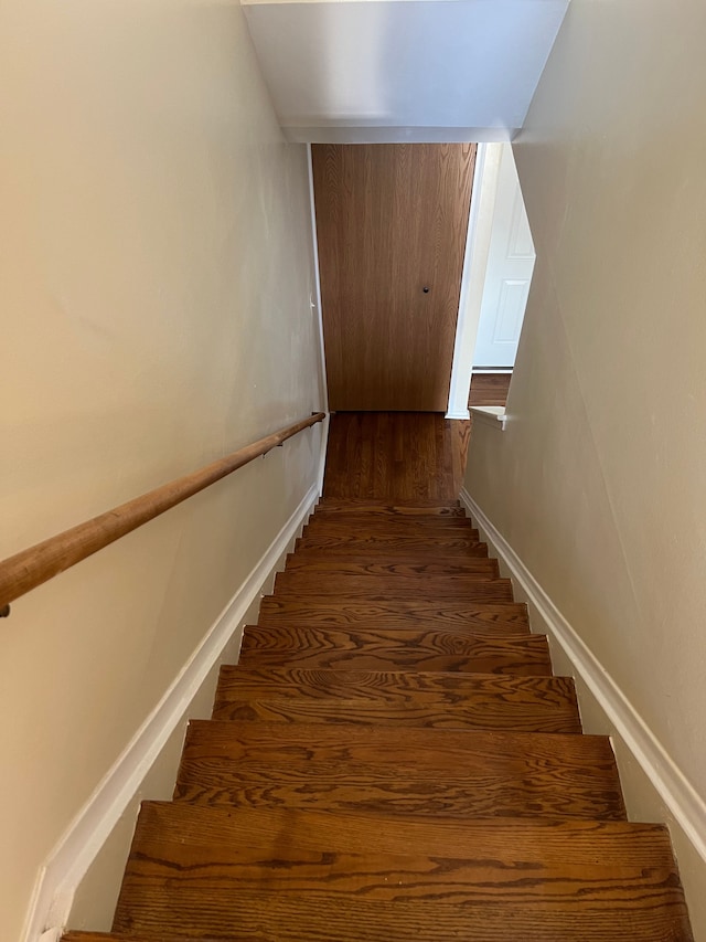 stairway featuring hardwood / wood-style flooring