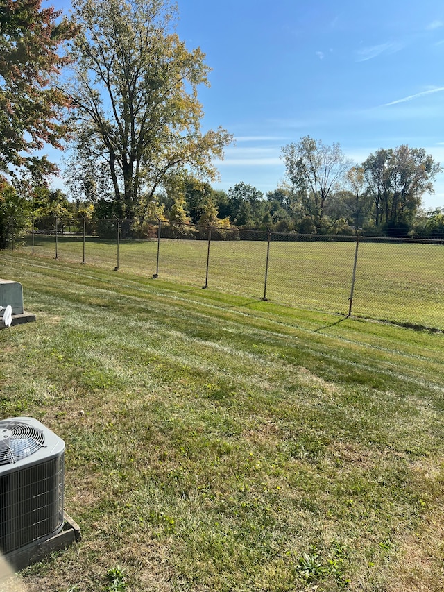 view of yard with a rural view and central AC unit