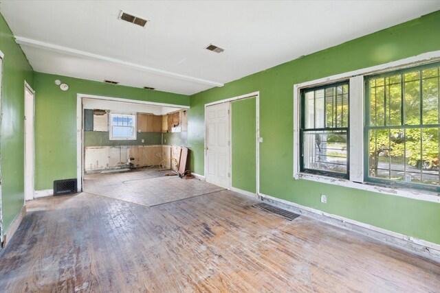 2515 Bagley St, Flint, MI 48504 - unfurnished living room with wood finished floors and baseboards