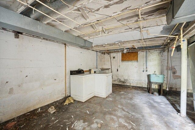 2515 Bagley St, Flint, MI 48504 - unfinished basement featuring washer and clothes dryer and a sink