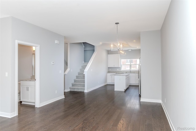 25495 Grandview Ln Unit 25, Novi, MI 48375 - unfurnished living room featuring dark wood-style floors, a chandelier, stairs, and recessed lighting
