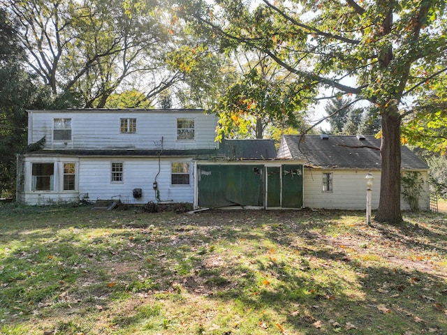 rear view of house with a yard