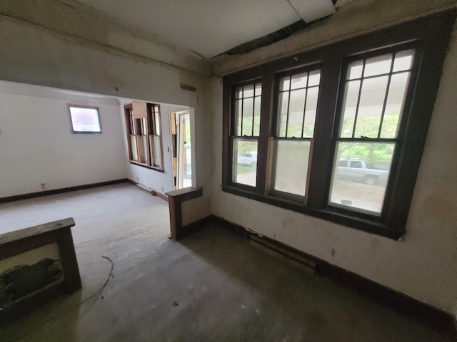 unfurnished room featuring concrete flooring and a wealth of natural light