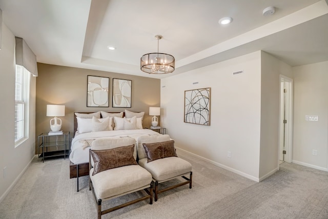 bedroom featuring a chandelier, recessed lighting, light carpet, baseboards, and a raised ceiling