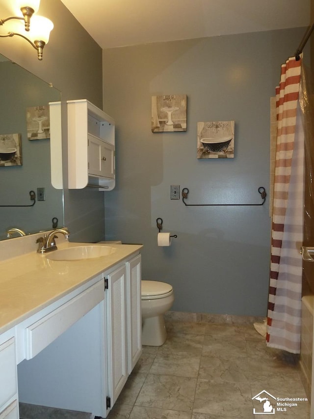 bathroom featuring vanity and toilet