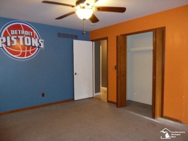 unfurnished bedroom featuring ceiling fan, a closet, and carpet floors