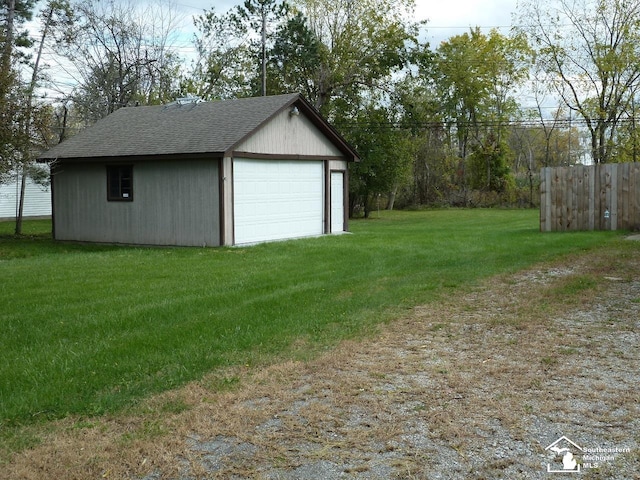 garage featuring a lawn