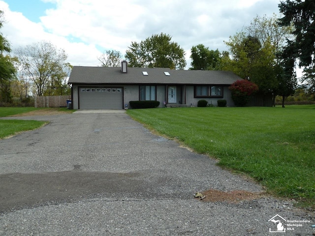 single story home with a garage and a front lawn