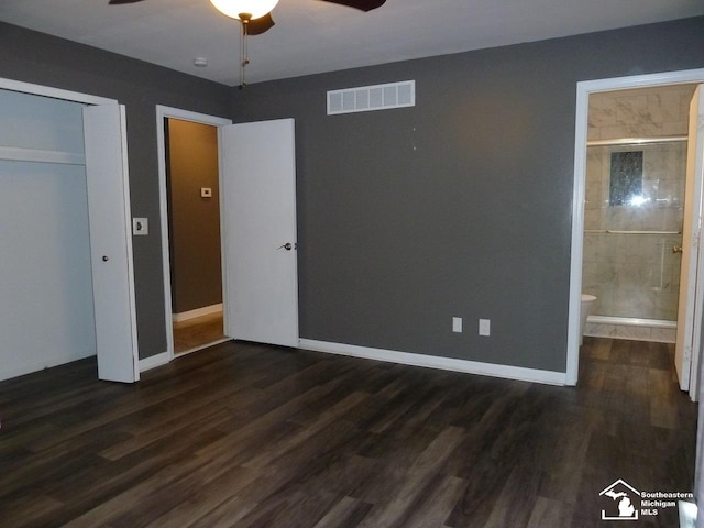 unfurnished bedroom with ceiling fan, ensuite bathroom, and dark hardwood / wood-style floors