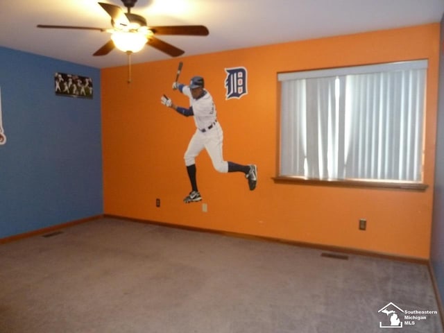 unfurnished room featuring light colored carpet and ceiling fan