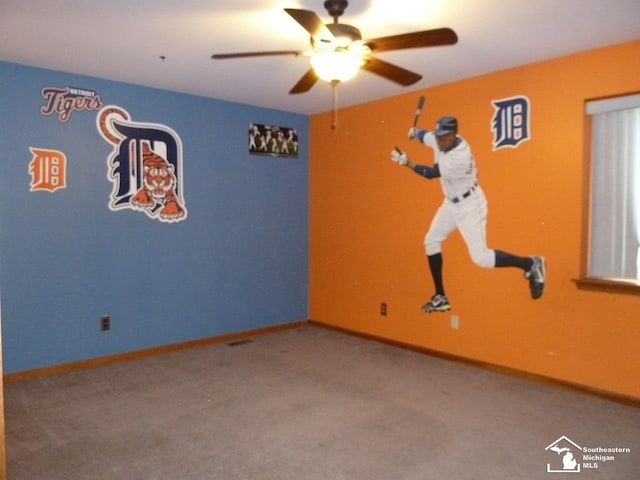 empty room with ceiling fan and carpet