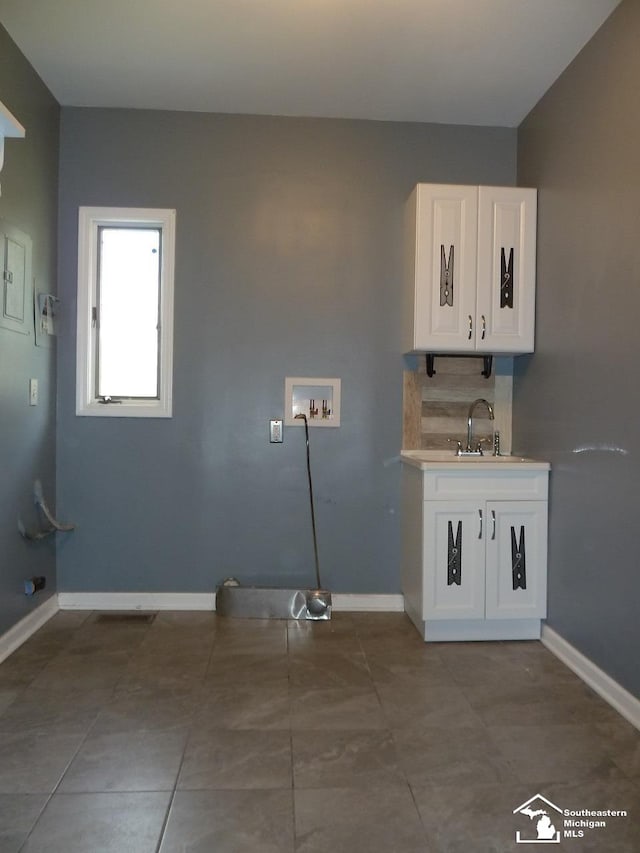 laundry room featuring tile patterned flooring, washer hookup, and sink