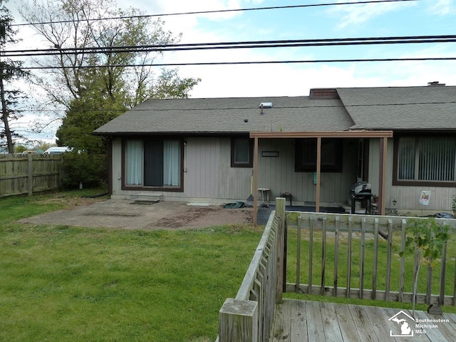 rear view of house featuring a lawn