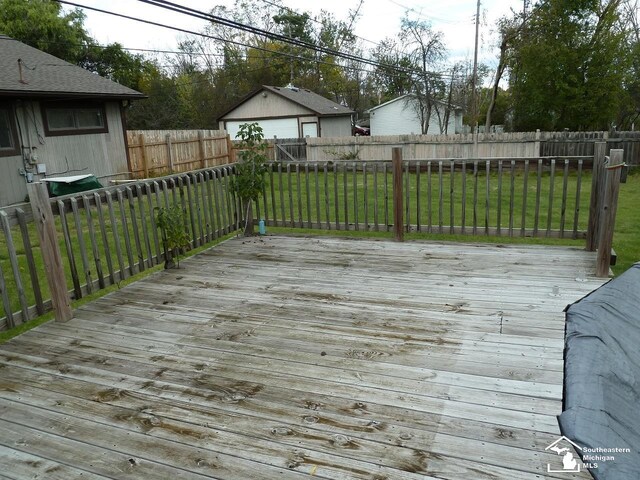 wooden terrace featuring a lawn