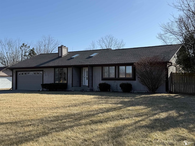 single story home featuring a shingled roof, fence, a front yard, an attached garage, and a chimney