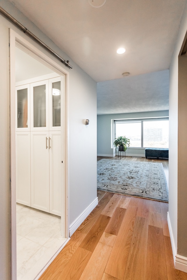 hallway with light hardwood / wood-style flooring