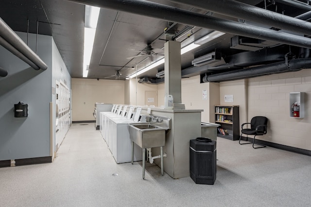 basement with washer and clothes dryer and sink