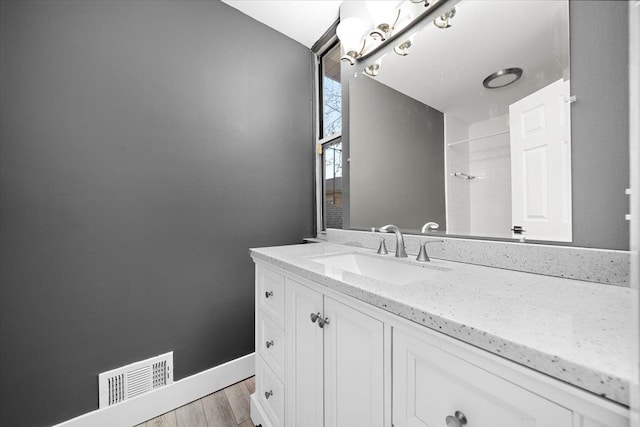 bathroom featuring vanity and hardwood / wood-style flooring