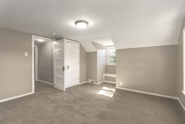 additional living space with carpet flooring and vaulted ceiling