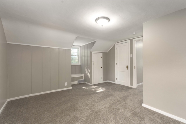 additional living space with carpet flooring and lofted ceiling