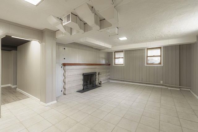 basement featuring a textured ceiling