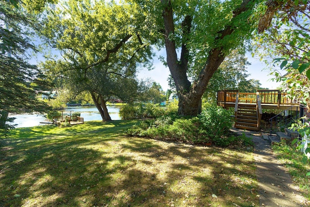 view of yard with a deck with water view