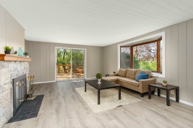 5721 Corunna Ave, Clarkston, MI 48346 - living area with a fireplace, wood finished floors, baseboards, and a decorative wall